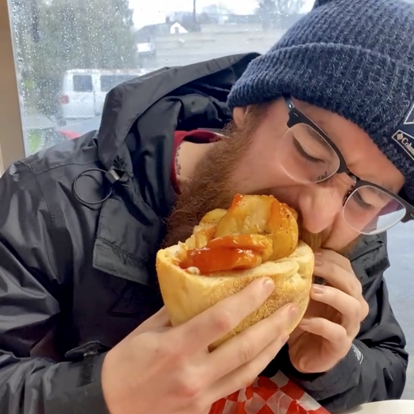 Nick munching down on an Italian hot dog.